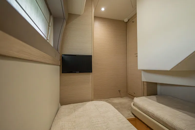 Navegante Yacht Photos Pics Interior of 2013 Ferretti Yachts 690 with twin beds and wall-mounted TV.