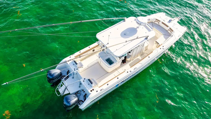 Complete Lunasea Yacht Photos Pics 2018 World Cat 320 CC boat on vibrant green water, aerial view.