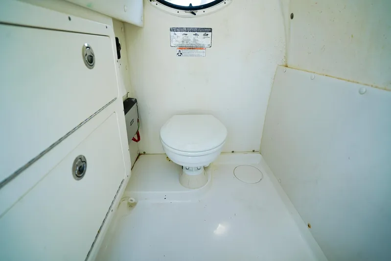 Complete Lunasea Yacht Photos Pics 2018 World Cat 320 CC boat interior with compact marine toilet and storage cabinets.