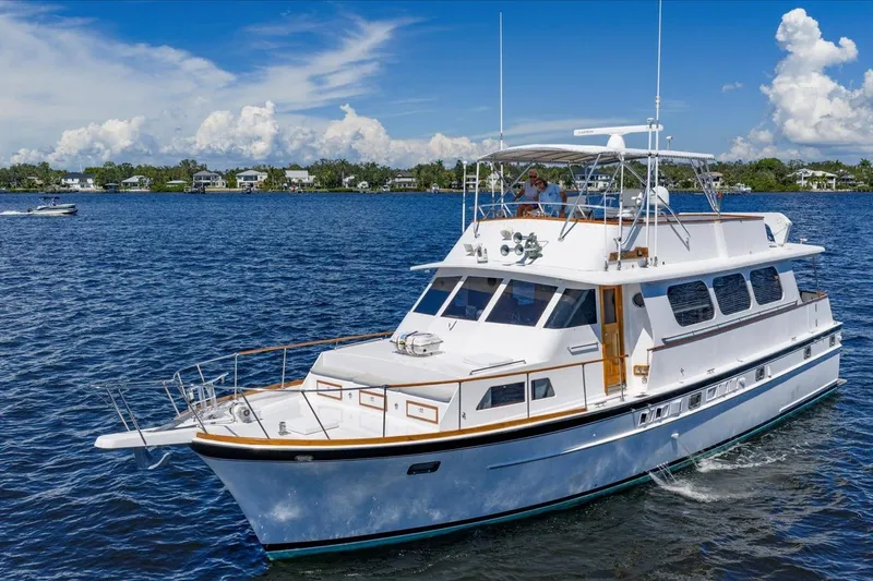  Yacht Photos Pics 1971 Matthews Voyager yacht cruising on a sunny day with clear blue skies.