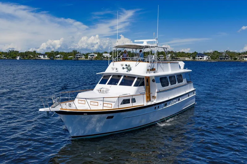  Yacht Photos Pics 1971 Matthews Voyager yacht cruising on a sunny day with scenic waterfront homes.