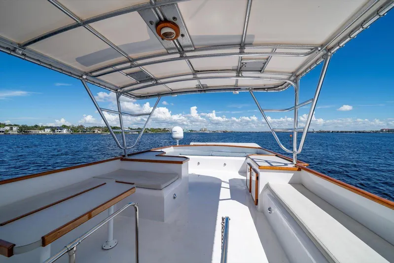  Yacht Photos Pics 1971 Matthews Voyager boat deck with canopy, overlooking serene blue waters and distant shoreline.