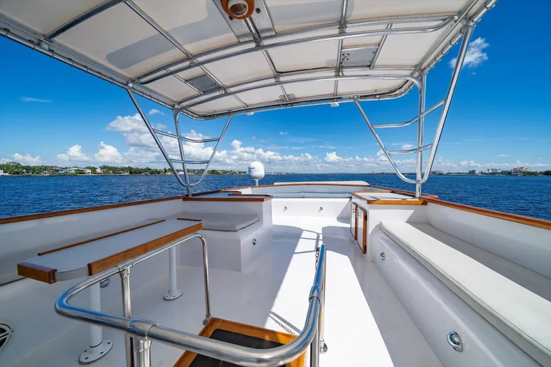  Yacht Photos Pics 1971 Matthews Voyager boat deck with seating, overlooking calm blue waters and clear sky.