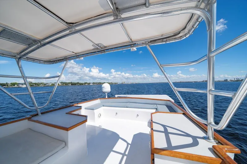  Yacht Photos Pics 1971 Matthews Voyager boat deck with canopy, overlooking serene blue waters and clear sky.