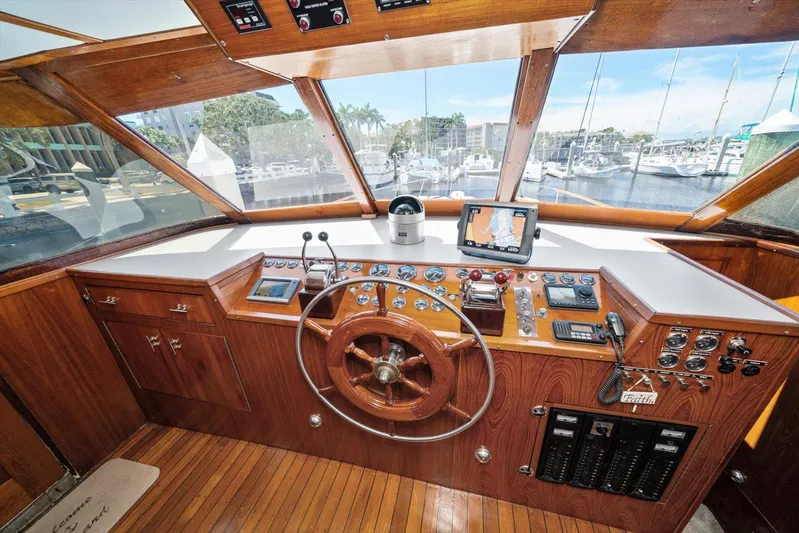  Yacht Photos Pics 1971 Matthews Voyager boat helm with wooden steering wheel, navigation instruments, and marina view.