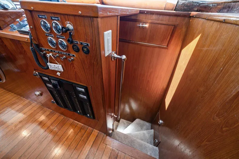  Yacht Photos Pics 1971 Matthews Voyager interior with wooden paneling, control gauges, and staircase.