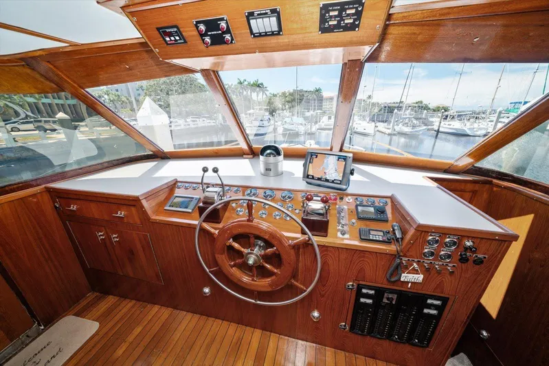  Yacht Photos Pics 1971 Matthews Voyager boat helm with wooden dashboard, steering wheel, and navigation equipment.