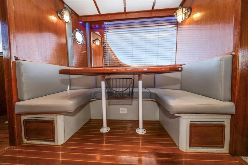  Yacht Photos Pics 1971 Matthews Voyager boat interior with wooden paneling and cozy dining area.
