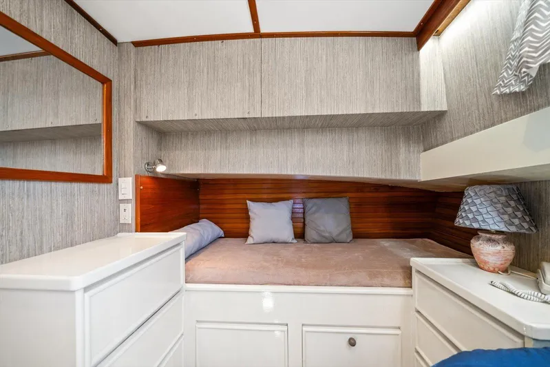  Yacht Photos Pics Cozy cabin interior of 1971 Matthews Voyager with bed, pillows, and wooden accents.