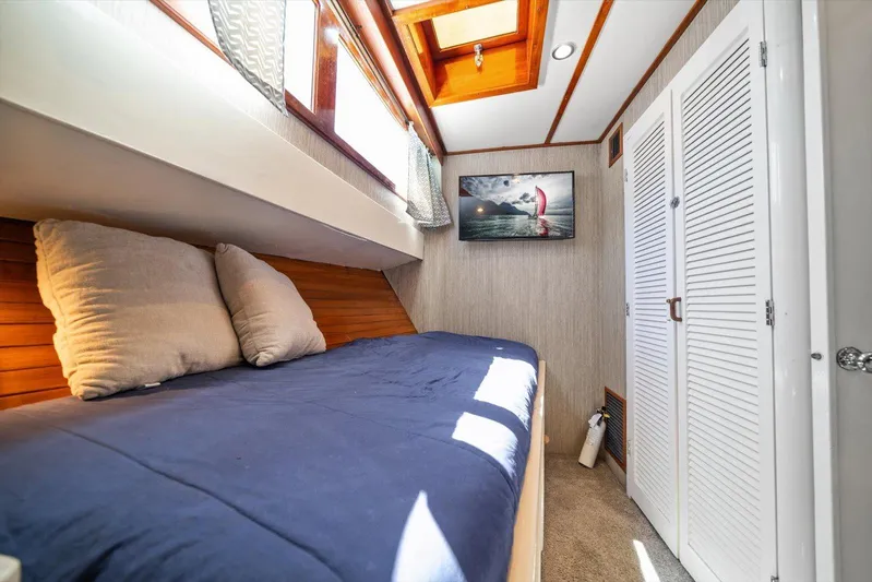  Yacht Photos Pics Cozy cabin interior of 1971 Matthews Voyager with bed, pillows, and wall art.