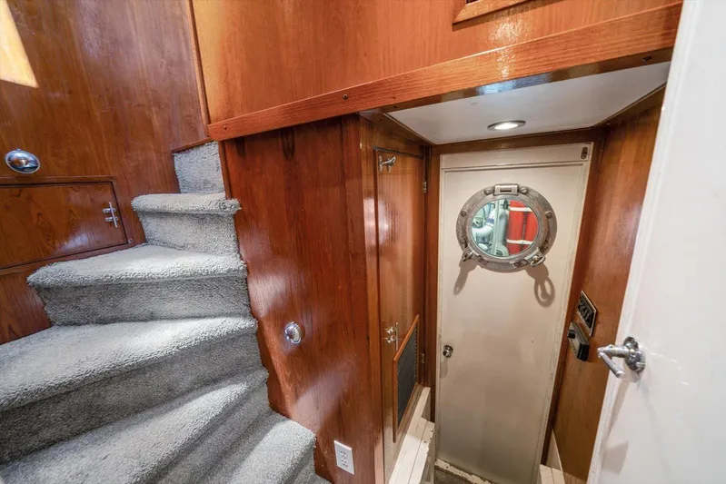  Yacht Photos Pics Interior of 1971 Matthews Voyager yacht with carpeted stairs and porthole door.