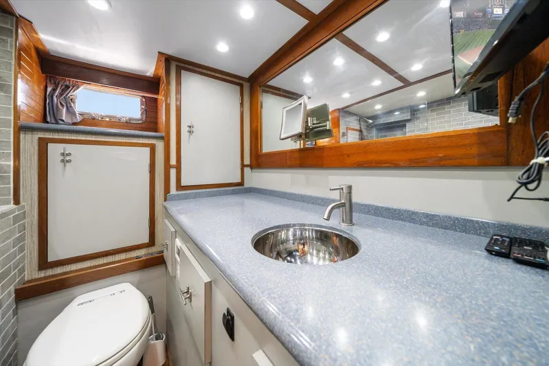  Yacht Photos Pics Luxurious 1971 Matthews Voyager bathroom with modern fixtures, wood accents, and ample lighting.