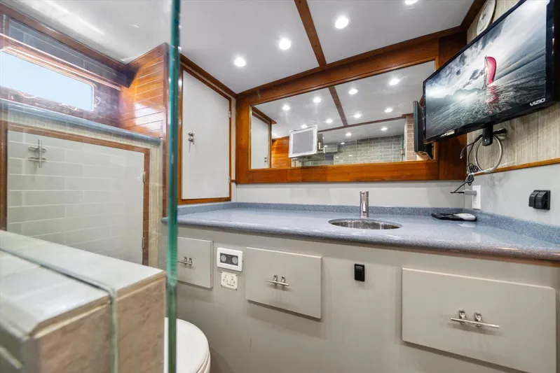  Yacht Photos Pics Luxurious 1971 Matthews Voyager bathroom with modern fixtures and mounted TV.