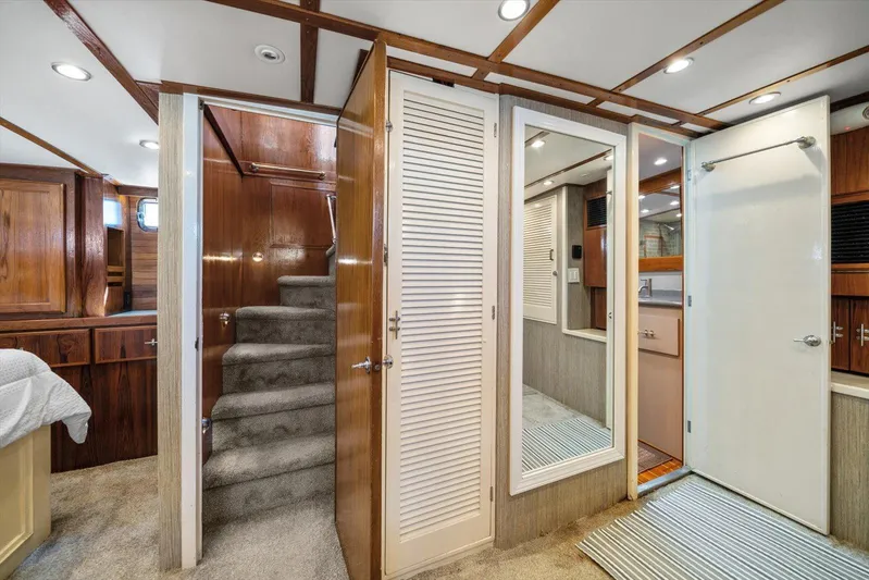 Yacht Photos Pics 1971 Matthews Voyager interior with carpeted stairs, wood paneling, and modern lighting.