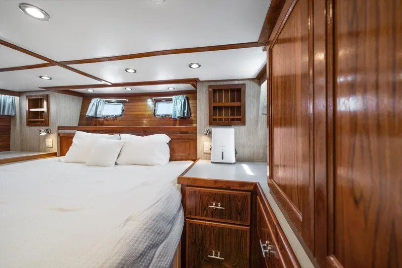  Yacht Photos Pics Luxurious 1971 Matthews Voyager cabin with wood paneling and cozy bedding.