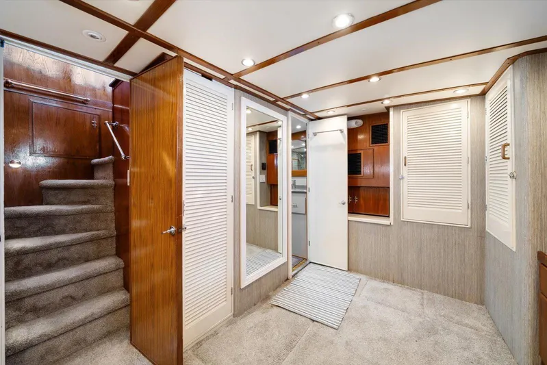  Yacht Photos Pics Interior of a 1971 Matthews Voyager yacht with wood paneling and carpeted stairs.