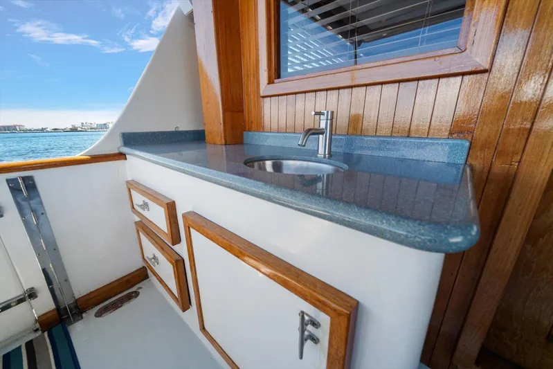  Yacht Photos Pics 1971 Matthews Voyager boat interior with wooden cabinetry and blue countertop sink.