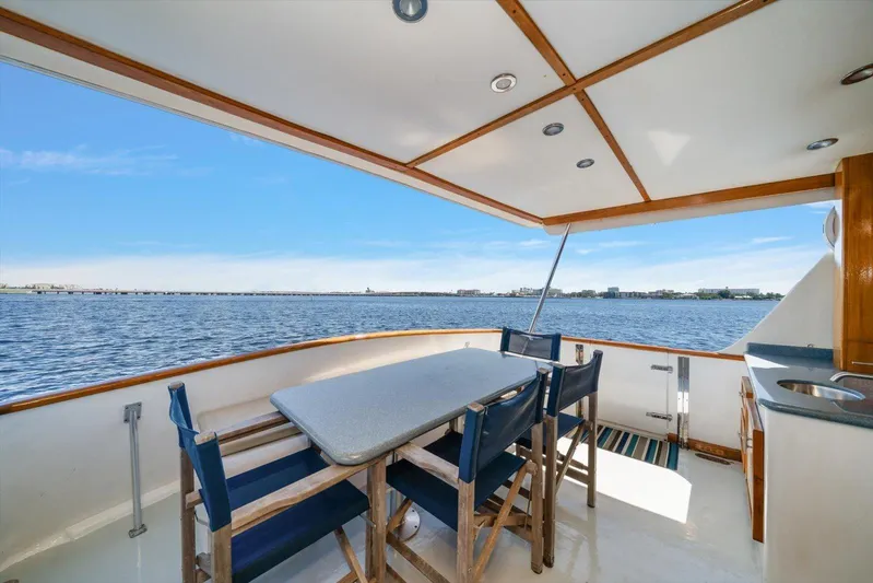  Yacht Photos Pics 1971 Matthews Voyager yacht deck with dining area overlooking serene water view.