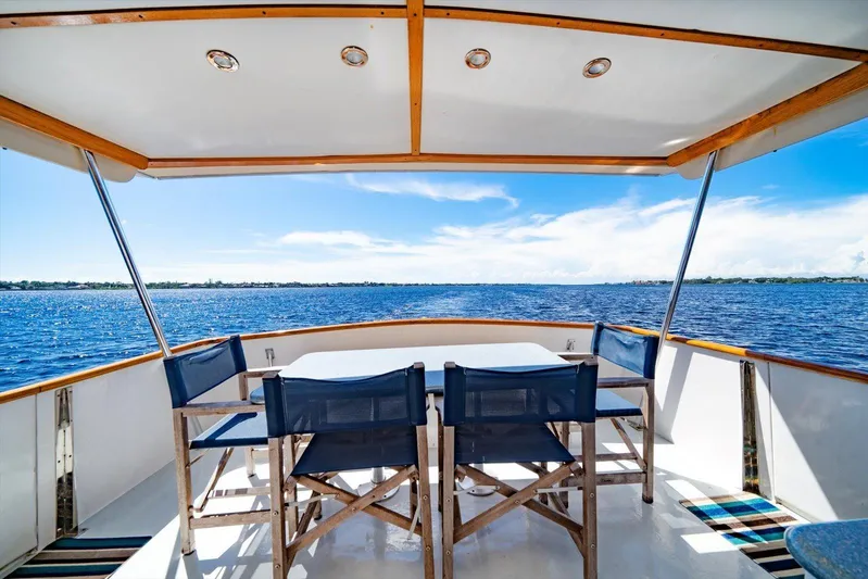  Yacht Photos Pics 1971 Matthews Voyager boat deck with chairs, overlooking serene blue waters and clear sky.