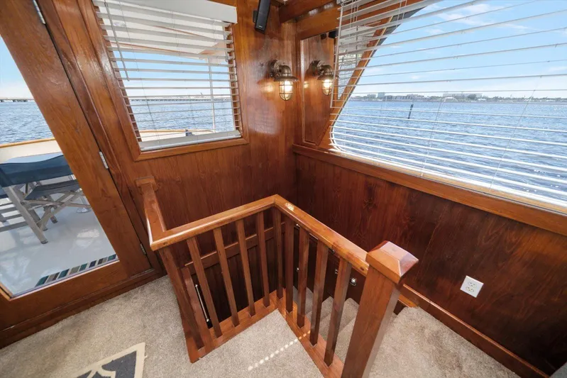  Yacht Photos Pics Wooden interior of 1971 Matthews Voyager yacht with staircase and ocean view.