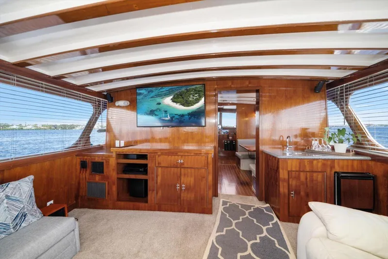  Yacht Photos Pics Luxurious 1971 Matthews Voyager yacht interior with wood paneling, TV, and kitchenette.