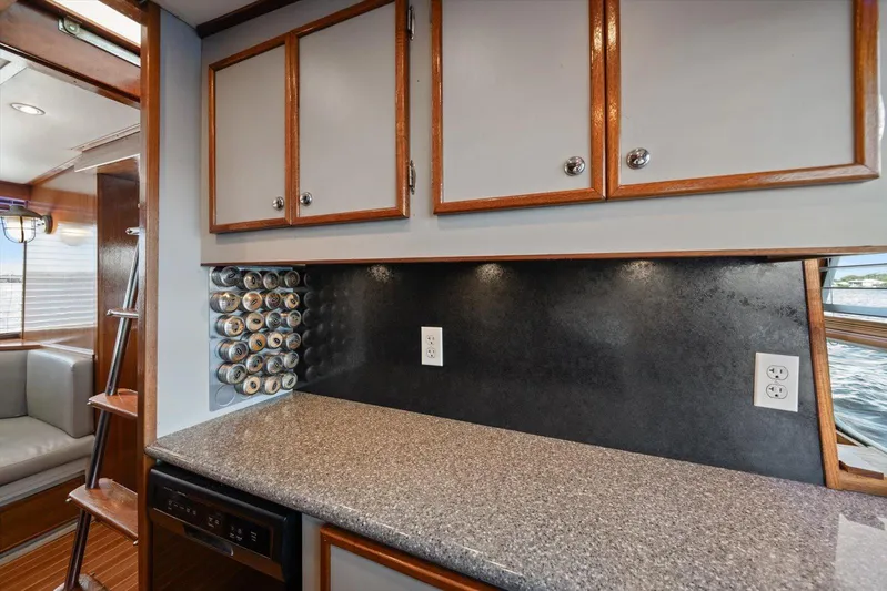  Yacht Photos Pics 1971 Matthews Voyager kitchen with granite countertop, spice rack, and wooden cabinets.