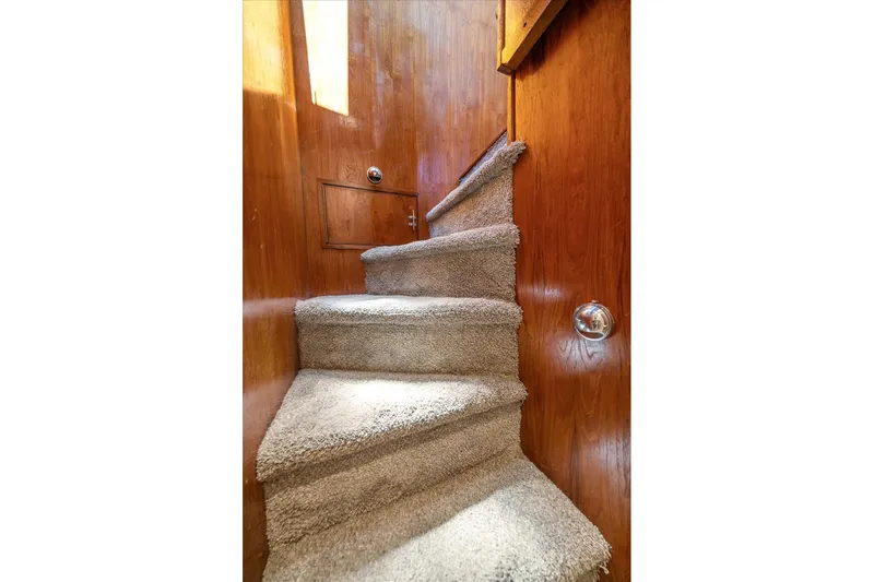  Yacht Photos Pics Carpeted stairs inside a 1971 Matthews Voyager boat with wooden paneling.