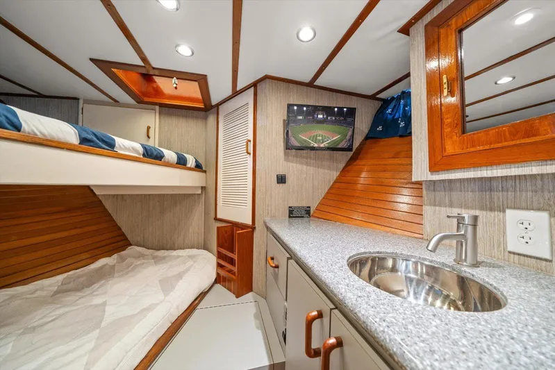  Yacht Photos Pics Cozy 1971 Matthews Voyager cabin with bunk beds, TV, and modern sink.