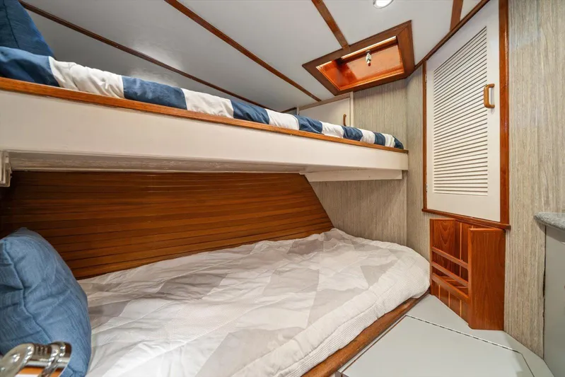  Yacht Photos Pics 1971 Matthews Voyager cabin interior with wooden bunk beds and cozy bedding.