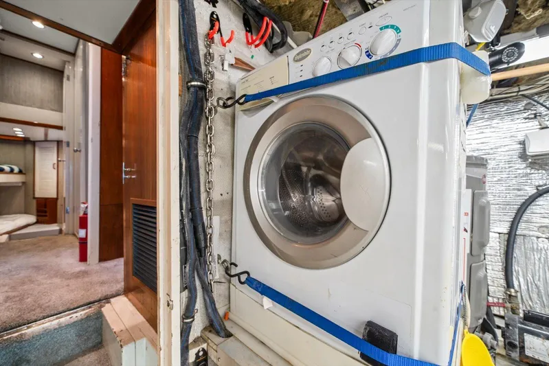  Yacht Photos Pics Laundry area inside a 1971 Matthews Voyager boat, featuring a secured washing machine.