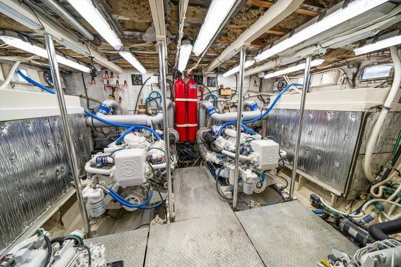  Yacht Photos Pics Engine room of a 1971 Matthews Voyager boat, featuring dual engines and metallic surfaces.