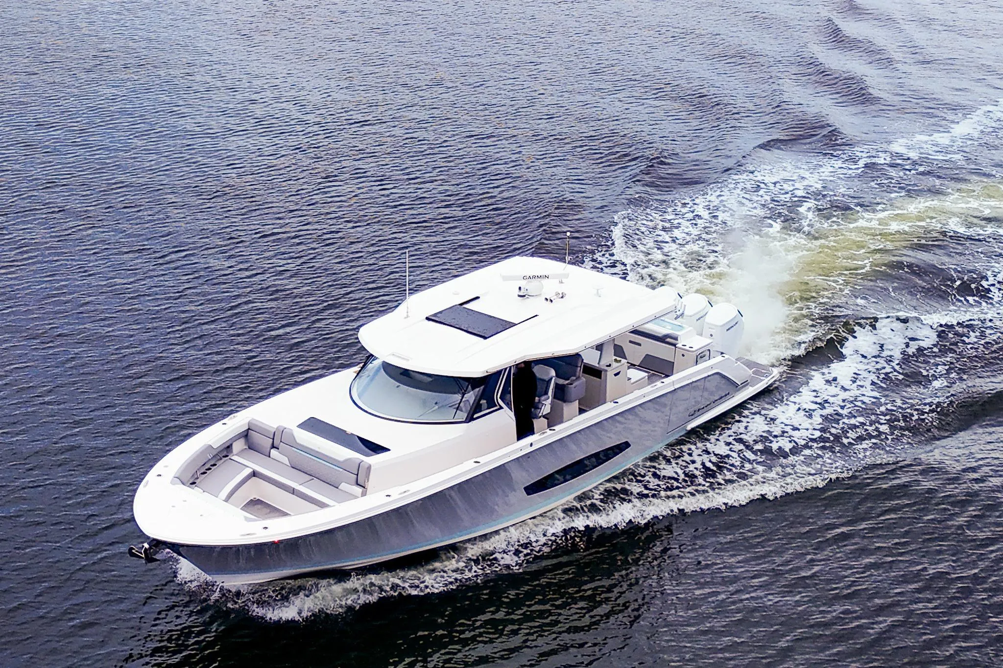 Aerial view of 2025 Regal 50 SAV yacht cruising on open water.