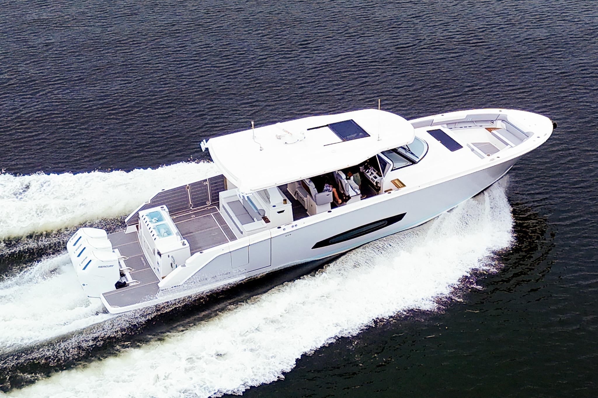 2025 Regal 50 SAV yacht cruising on open water, showcasing sleek design and powerful engines.