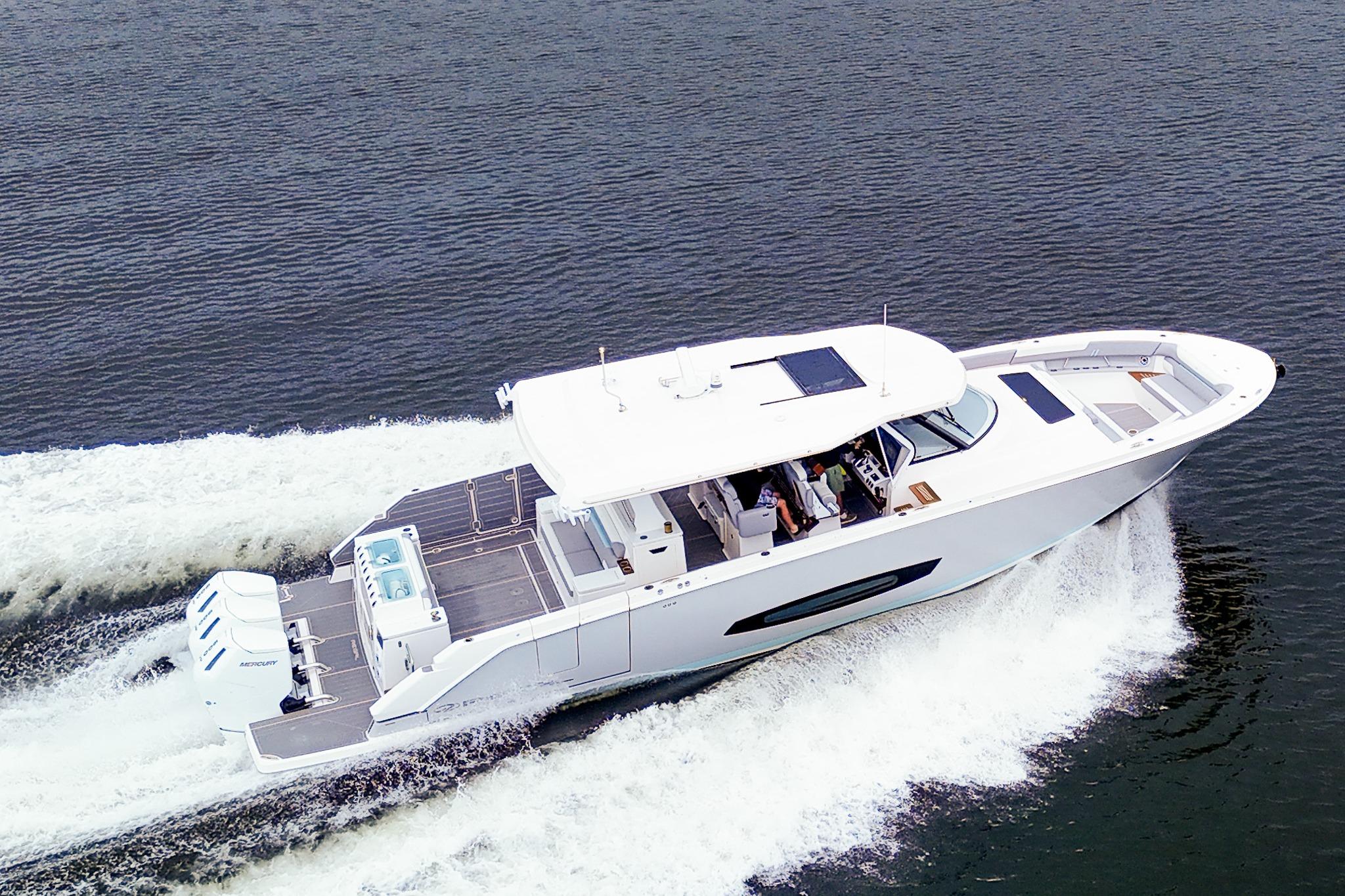 2025 Regal 50 SAV yacht cruising on open water, showcasing sleek design and powerful engines.