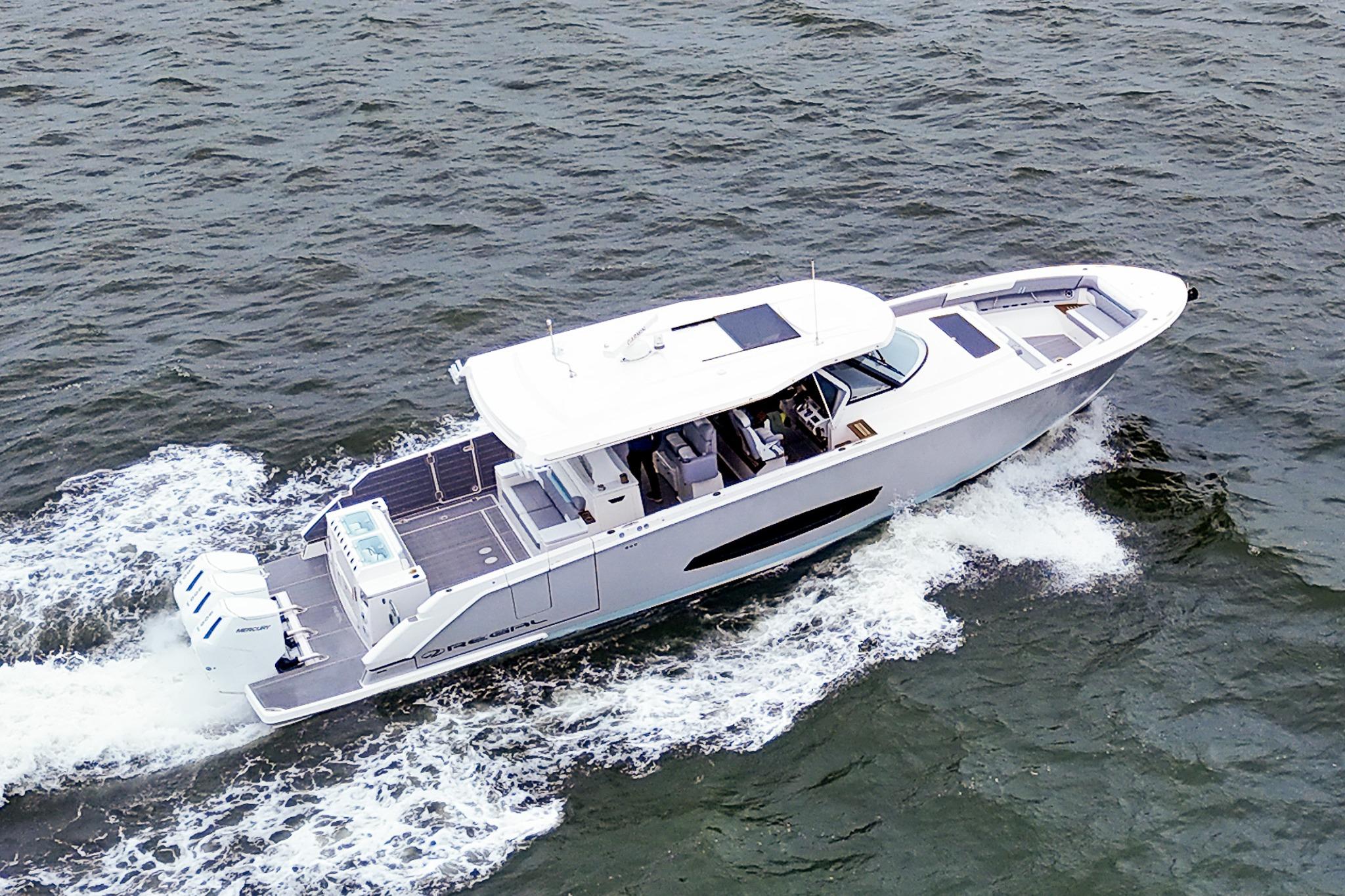 2025 Regal 50 SAV yacht cruising on open water, showcasing sleek design and powerful engines.