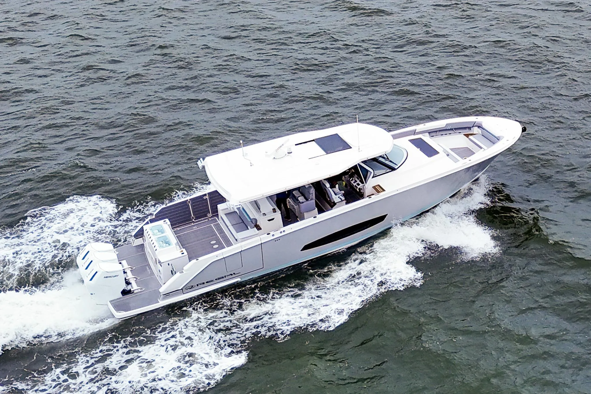 2025 Regal 50 SAV yacht cruising on open water, showcasing sleek design and powerful engines.