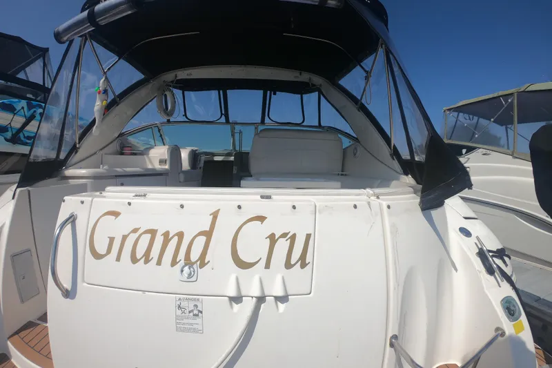 Grandcru Yacht Photos Pics 2005 Cruisers Yachts 340 Express boat named "Grand Cru" docked under clear blue sky.
