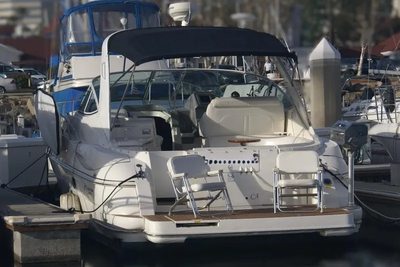 Grandcru Yacht Photos Pics 2005 Cruisers Yachts 340 Express docked at marina, rear view with seating area.