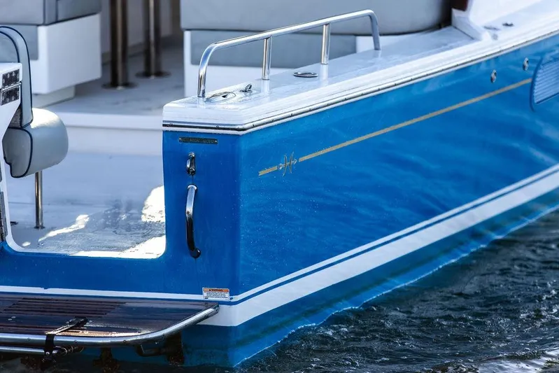 Theresa Anne III Yacht Photos Pics 2012 Hunt Yachts Harrier 36 Express, blue hull detail, docked on water.