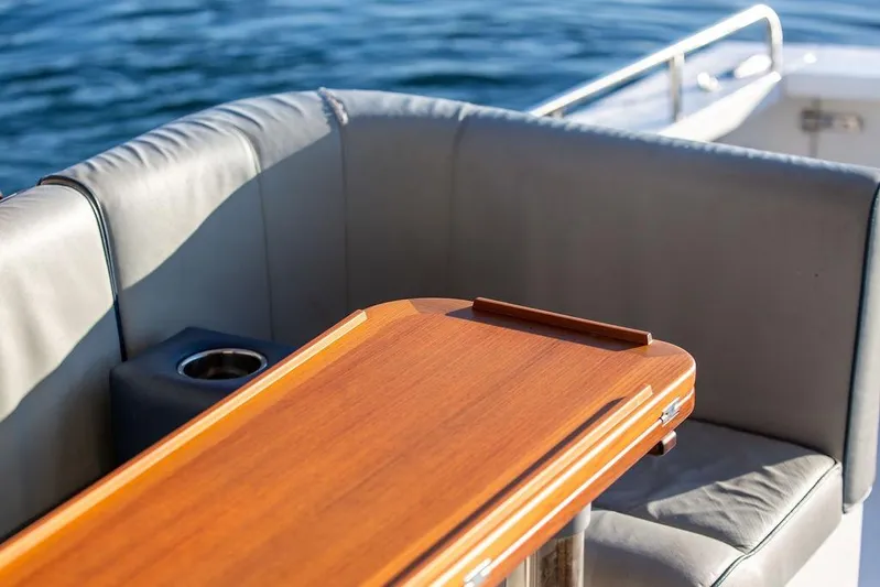 Theresa Anne III Yacht Photos Pics Luxury seating area on 2012 Hunt Yachts Harrier 36 Express with wooden table.