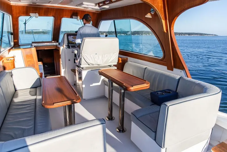 Theresa Anne III Yacht Photos Pics Interior of 2012 Hunt Yachts Harrier 36 Express with elegant seating and wooden accents.