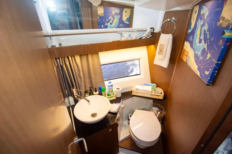 Sea Scape Yacht Photos Pics 2021 Jeanneau NC 1095 boat bathroom with sink, toilet, and nautical decor.