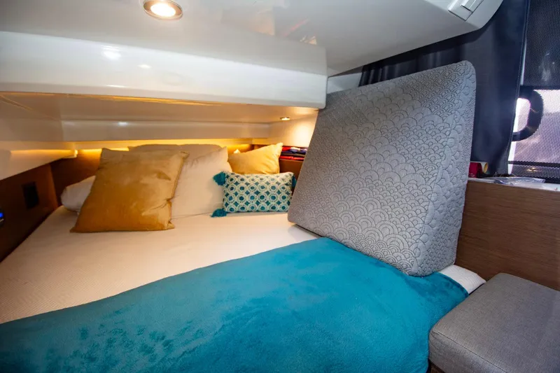 Sea Scape Yacht Photos Pics Cozy cabin interior of 2021 Jeanneau NC 1095 with plush bedding and ambient lighting.