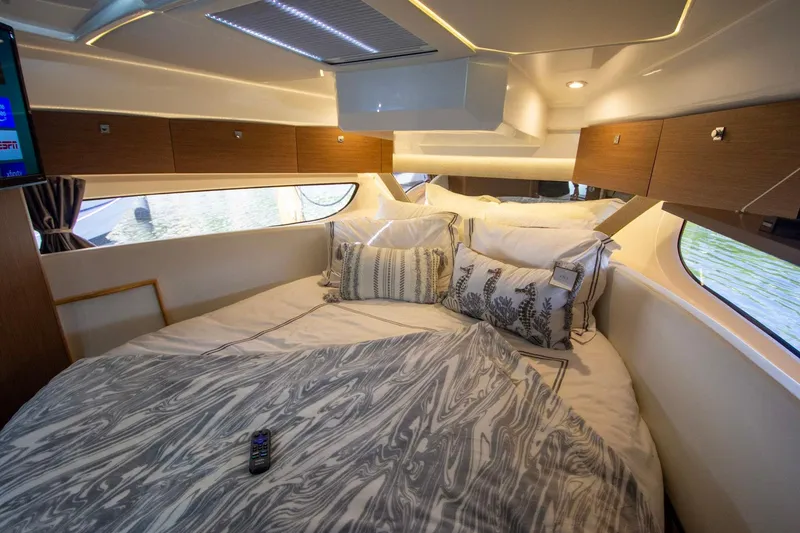 Sea Scape Yacht Photos Pics Luxurious cabin interior of 2021 Jeanneau NC 1095 with cozy bedding and modern design.