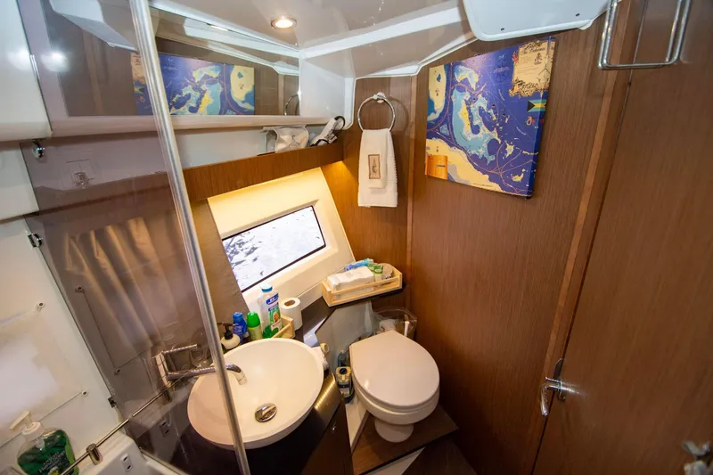 Sea Scape Yacht Photos Pics Modern bathroom in 2021 Jeanneau NC 1095 boat with sink, toilet, and nautical decor.