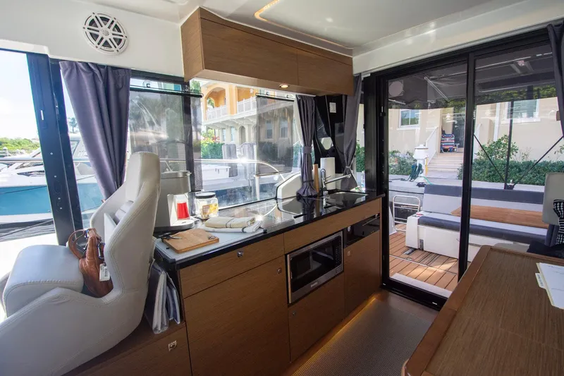 Sea Scape Yacht Photos Pics Interior of 2021 Jeanneau NC 1095 boat with modern kitchen and seating area.