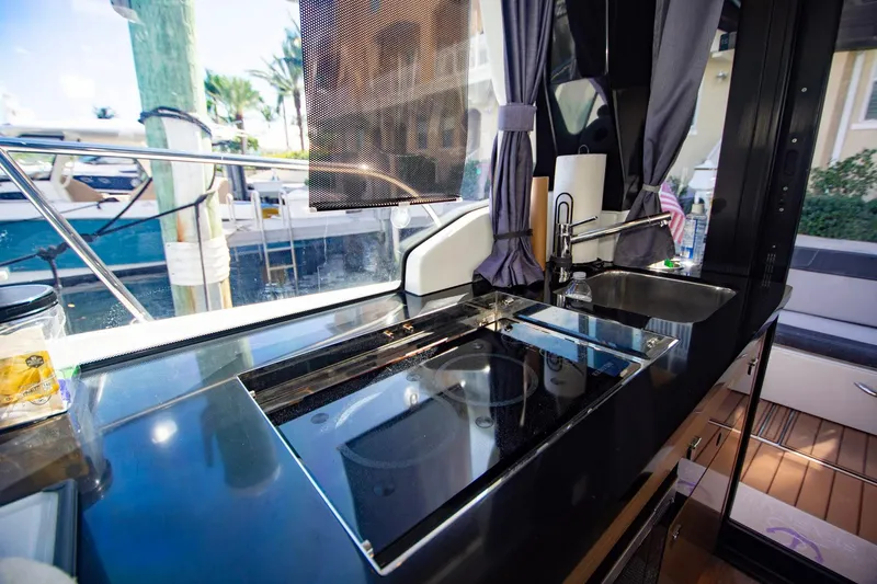 Sea Scape Yacht Photos Pics Modern kitchen area on a 2021 Jeanneau NC 1095 boat, featuring sleek countertops.