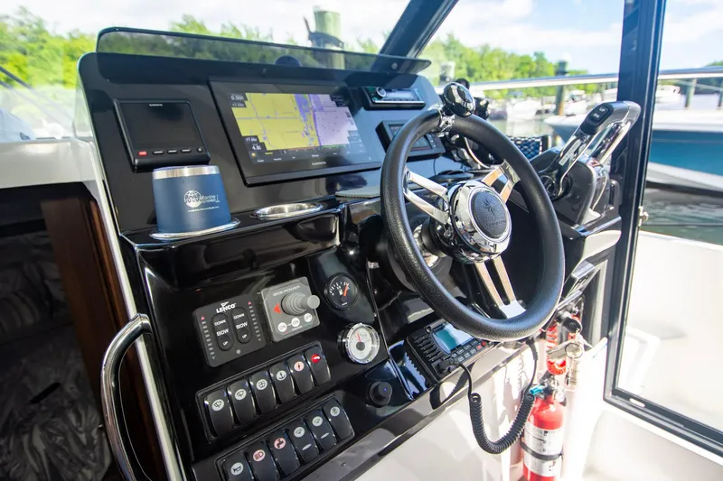 Sea Scape Yacht Photos Pics 2021 Jeanneau NC 1095 helm with navigation controls and steering wheel.