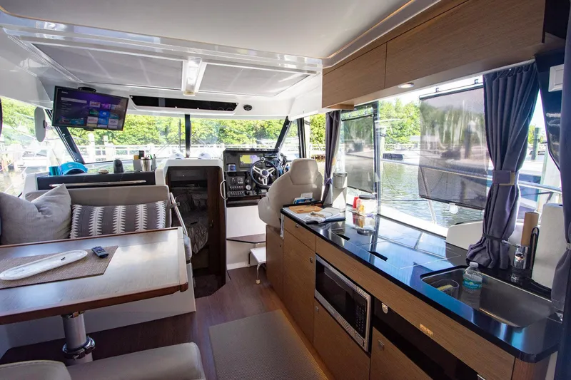 Sea Scape Yacht Photos Pics Interior of 2021 Jeanneau NC 1095 boat with modern kitchen and seating area.