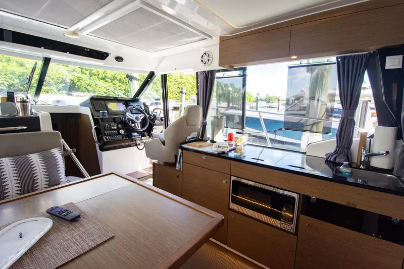 Sea Scape Yacht Photos Pics Interior of 2021 Jeanneau NC 1095 boat with modern helm and kitchen area.